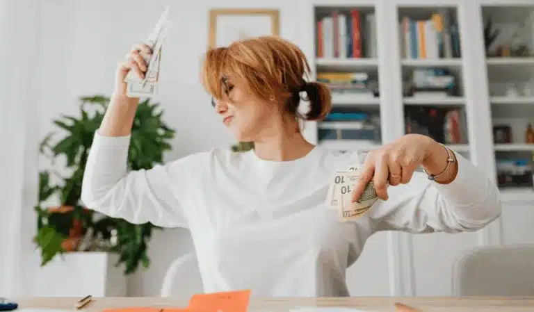 Woman celebrating money savings.