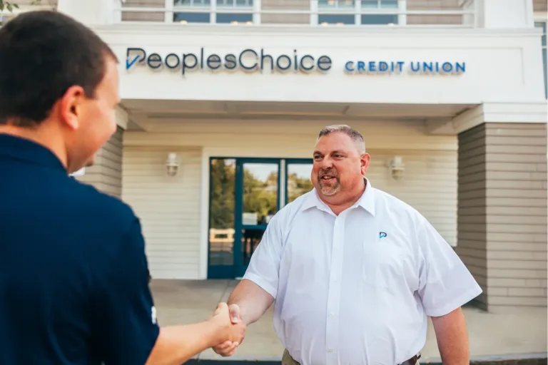 VP of Mortgage Lending, Kurt Schickle shakes hands with a member.