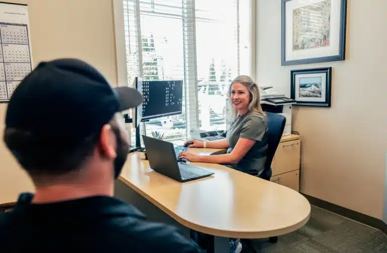 PeoplesChoice Mortgage Loan Officer sits with a member.